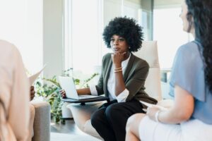 Executive leader listening to colleagues during a collaborative leadership conversation